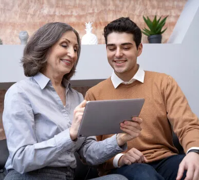 Two people looking at a ipad